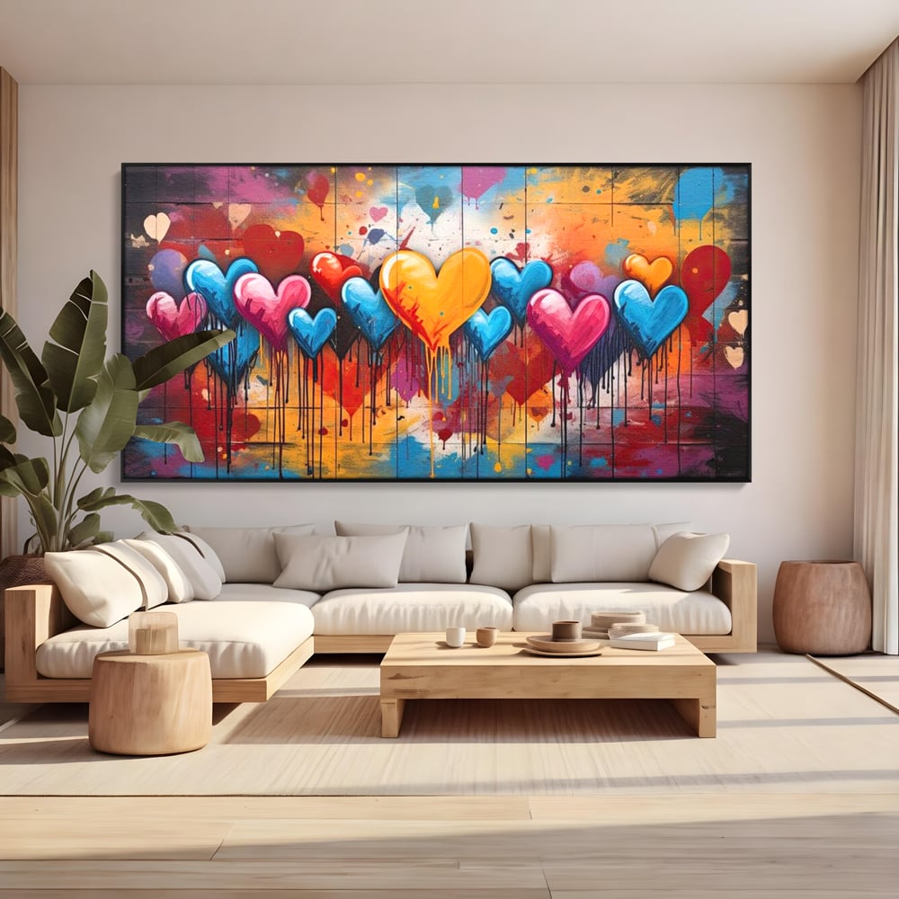 Tablou canvas cu tablou canvas cu inimi colorate, in rama de aluminiu negru, pe perete intr-un living